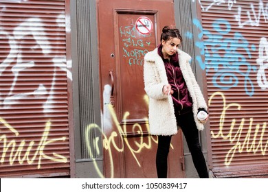 Young Pretty Stylish Teenage Girl Outside In City Wall With Graf