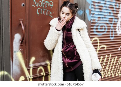 Young Pretty Stylish Teenage Girl Outside In City Wall With Graf