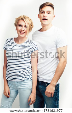 young pretty teenage couple, hipster guy with his girlfriend happy smiling and hugging isolated on white background, lifestyle people concept