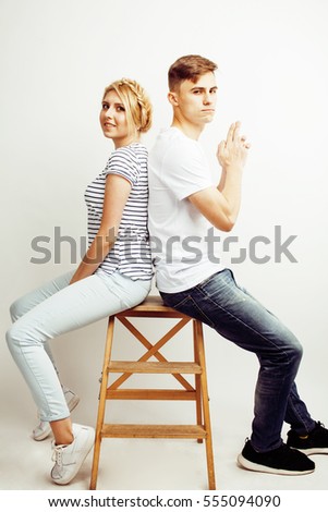 young pretty teenage couple, hipster guy with his girlfriend happy smiling and hugging isolated on white background, lifestyle people concept