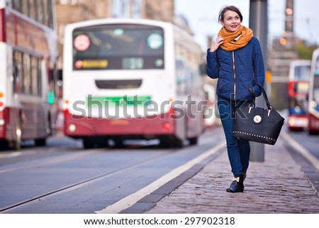 Young pretty teenage girl walking in the middle of Princess street in Edinburgh city