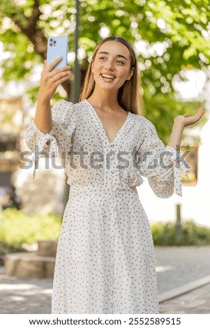 Similar – Image, Stock Photo Young woman vlogging outdoors with a mobile gimbal