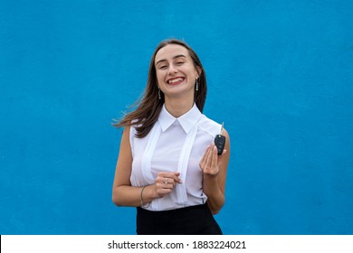 Young Pretty Woman In Business Cloth Hold Car Key On Blue Background