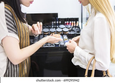 Young Pretty Woman Chosing Color Cosmetic And Beauty Consultant In Shop Or Beauty Salon