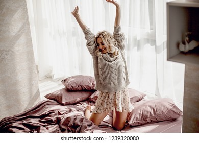 young pretty woman dancing in  bed int the morning