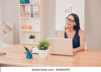 Young Pretty Woman Dreaming In Office Instead Of Doing Her Job