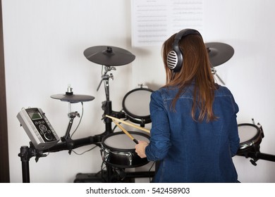 Young Pretty Woman Drummer Practicing  Electronic Drum Kit