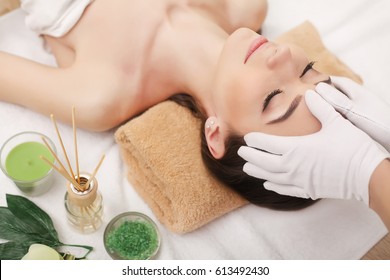 Young Pretty Woman Enjoying Face Massage Procedure