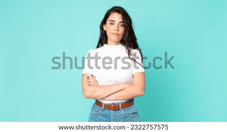 young pretty woman feeling displeased and disappointed, looking serious, annoyed and angry with crossed arms