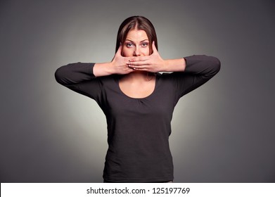 Young Pretty Woman Holding Hands Over Her Mouth Over Grey Background