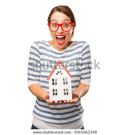 young pretty woman holding a small house
