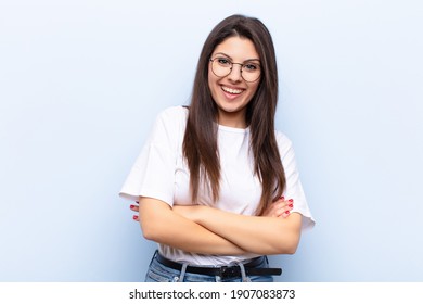 Young Pretty Woman Looking Like A Happy, Proud And Satisfied Achiever Smiling With Arms Crossed