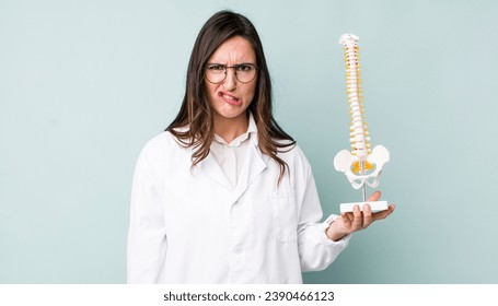 young pretty woman  looking puzzled and confused. spine specialist concept