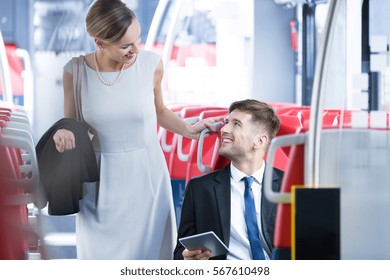 Young pretty woman meeting her elegant friend in the train