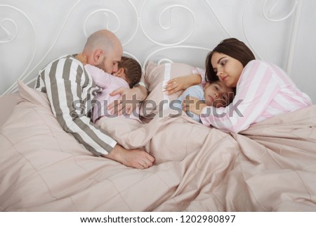 Similar – Relaxed mother and sons playing over the bed