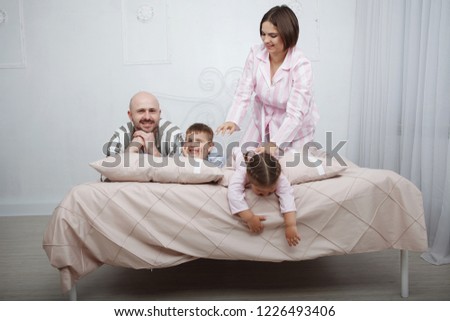 Little girl holding cookie sitting over the bed