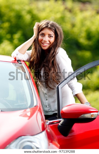 Young pretty woman in the red\
car