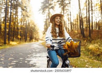 Young pretty woman riding bicycle in golden autumn park. Outdoor portrait. Active lifestyle. - Powered by Shutterstock