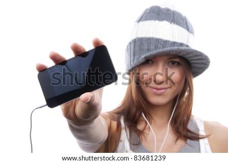 Young Pretty Woman Showing display of her new touch mobile cell phone and listen to music in earphonees. Focus on the hand and phone
