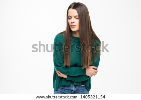 Young pretty woman with stomack pain wearing in green sweater isolated on white background