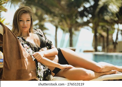 Young Pretty Woman At Swimming Pool Relaxing In Chair, Fashion Look In Lingerie At Hotel Close Up Smiling