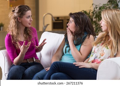 Young Pretty Woman Telling The Fascinating Story To Her Girlfriends