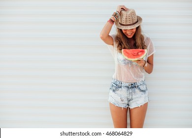 young pretty women holding a slice of watermelon in hands and smiling happy, summertime concept and mood, over an white background with lines - Powered by Shutterstock