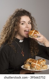 Young Priest Eating Hot Cross Buns A Tradition At Easter Time