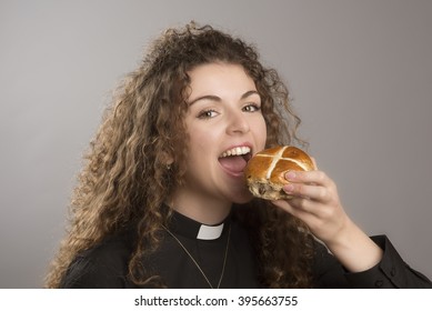 Young Priest Eating Hot Cross Buns A Tradition At Easter Time