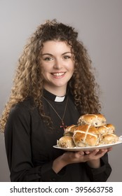 Young Priest Eating Hot Cross Buns A Tradition At Easter Time