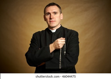 Young Priest With Rosary In His Hands