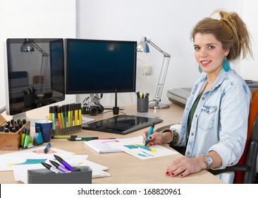 Young Product Designer Drawing Product Sketches At Her Desk