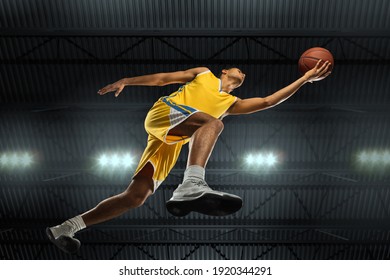 Young professional basketball player in action, motion isolated on black background, look from the bottom. Concept of sport, movement, energy and dynamic, healthy lifestyle. Training, practicing. - Powered by Shutterstock