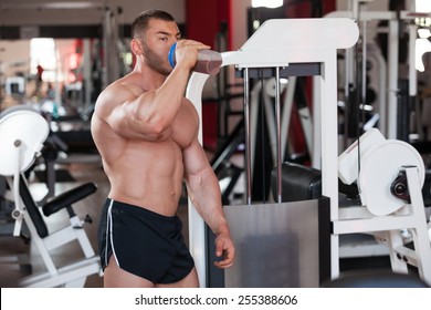 Young Professional Bodybuilder In The Gym, Drinking A Protein Shake