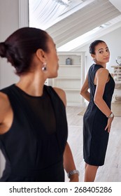 Young Professional Business Woman Checking Elegant Dress In Mirror Reflection At Home Bedroom