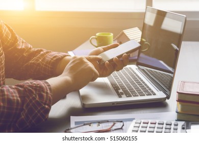 Young  professional businessman with smartphone, research data or document  discuss business planning market,using app texting sms message wearing Plaid shirt. - Powered by Shutterstock