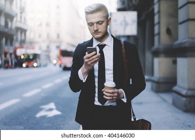 Young Professional Businessman Using Modern Smartphone Outdoors, Successful Lawyer Wearing Black Suit And Using His Cellphone While Going To The Work And Take Taxi