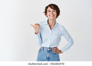 Young Professional Ceo Woman In Blue Collar Shirt, Smiling Happy And Pointing Left At Logo, Showing Promo Banner, Standing On White Background.