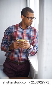 Young, professional and confident black business man thinking of ideas for a project. Serious African American male on a break contemplating as he looks at the view from work during a coffee break - Shutterstock ID 2188929771