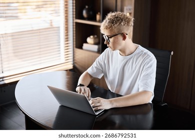 A Young Professional Engaged in Work While Using a Laptop at a Modern Stylish Desk - Powered by Shutterstock - Get 15% off with code: PIKWIZARD15
