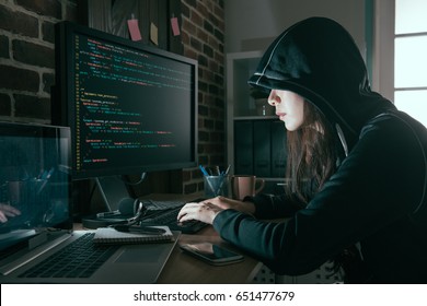 young professional female hacker using keyboard typing bad data into computer online system and spreading to global stolen personal information.