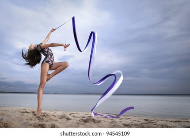 Young Professional Gymnast Woman Dance With Ribbon - Outdoor Sand Beach