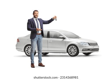 Young professional man holding a car key in front of a sliver car isolated on white background - Shutterstock ID 2314368981