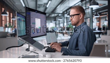 Young Professional Managing Cloud-Based Enterprise Software System On Laptop
