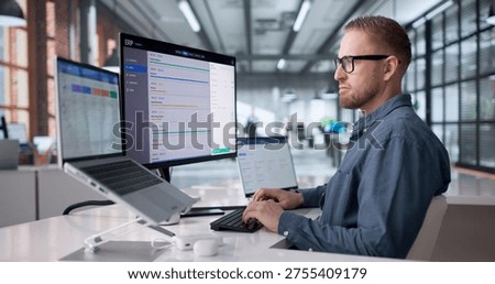 Young Professional Managing Cloud-Based ERP Software On Laptop For Business Optimization