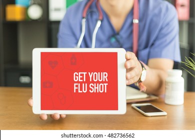 Young and professional medical doctor showing a tablet pc and GET YOUR FLU SHOT concept on screen