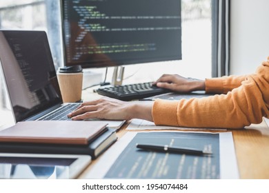 Young Professional programmer working at developing programming and website working in a software develop company office, writing codes and typing data code, Programming with HTML, PHP and javascript.