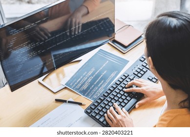 Young Professional programmer working at developing programming and website working in a software develop company office, writing codes and typing data code, Programming with HTML, PHP and javascript.