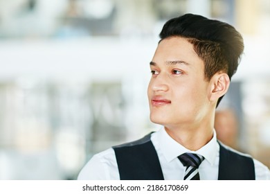 Young Professional Waiter, Bartender Or Host Looking Confident, Serious And Wearing Formal Uniform On A Blurred Background. Closeup Side Profile, Head And Face Of A Man Working In Hospitality