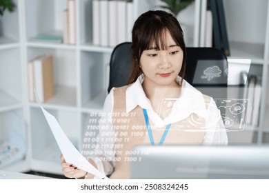 Young Professional Woman Analyzing Data on a Computer in a Modern Office Environment - Powered by Shutterstock